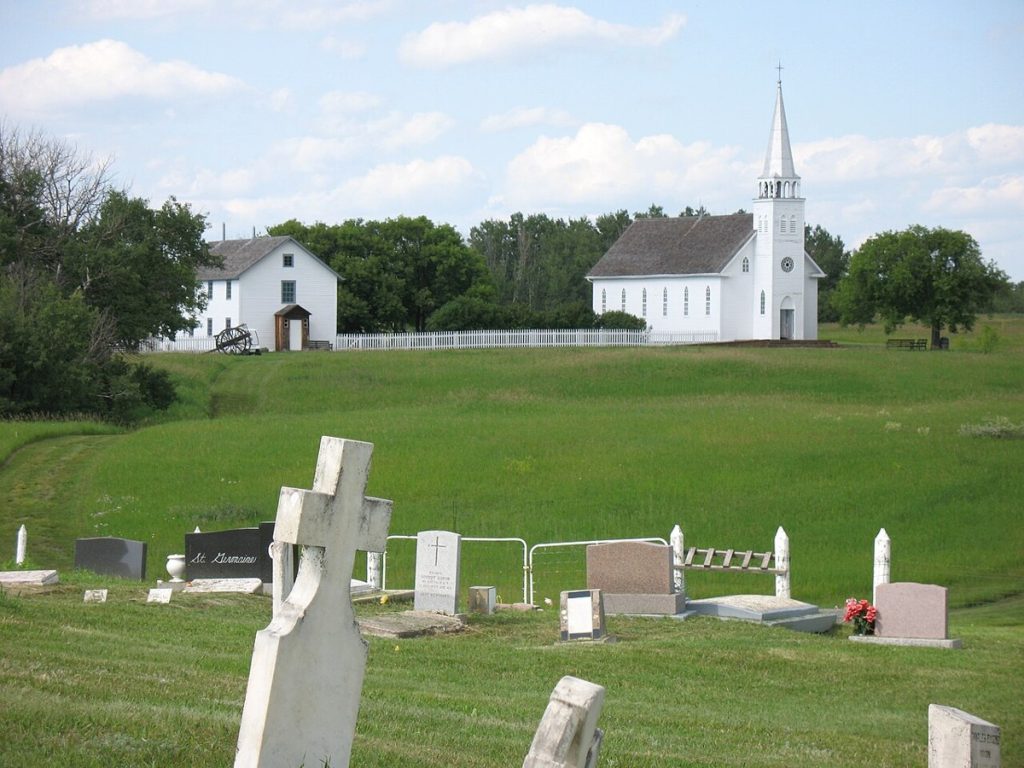 The church and rectory at Batoche National Historic Site, Saskatchewan, viewed from the cemetery in 2007.