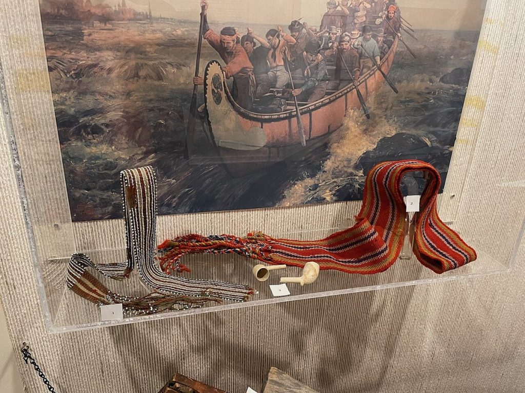 A beaded Métis sash and a ceinture fléchée (woven sash) on display at a museum in Sault Ste. Marie, Ontario, in 2024.