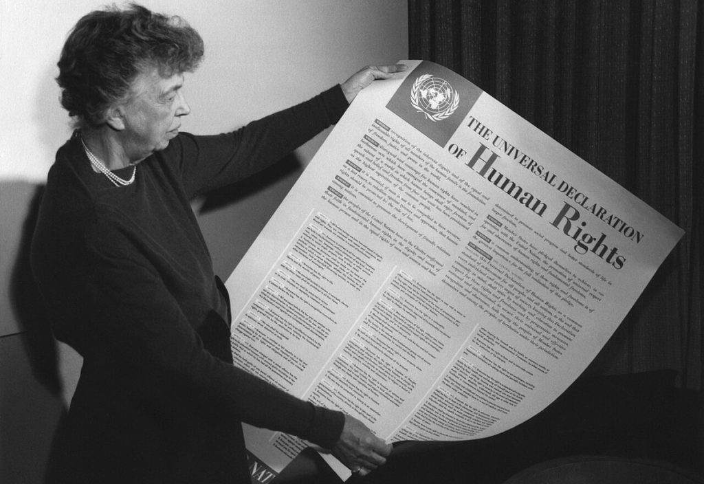 Eleanor Roosevelt holding a poster of the Universal Declaration of Human Rights, 1949; Humphrey does not appear in the photo.