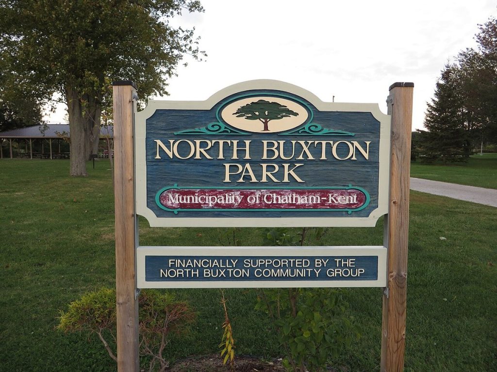 A sign for North Buxton Park in the Buxton Settlement area, Ontario, photographed in 2015; it does not show the settlement’s original buildings.
