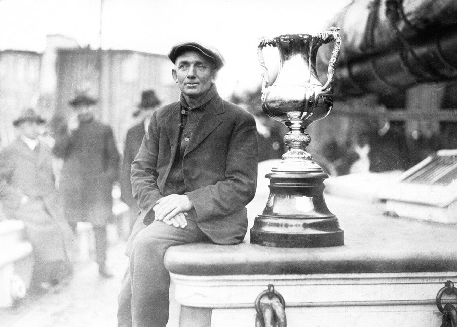 Captain Angus Walters with the International Fishermen’s Trophy on the deck of Bluenose, 1921 (W. R. MacAskill).